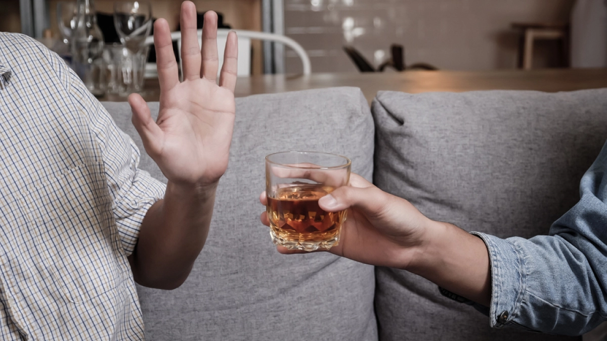 Image of man holding his hand out to reject alcohol. Text explains how personal factors affect alcohol tolerance