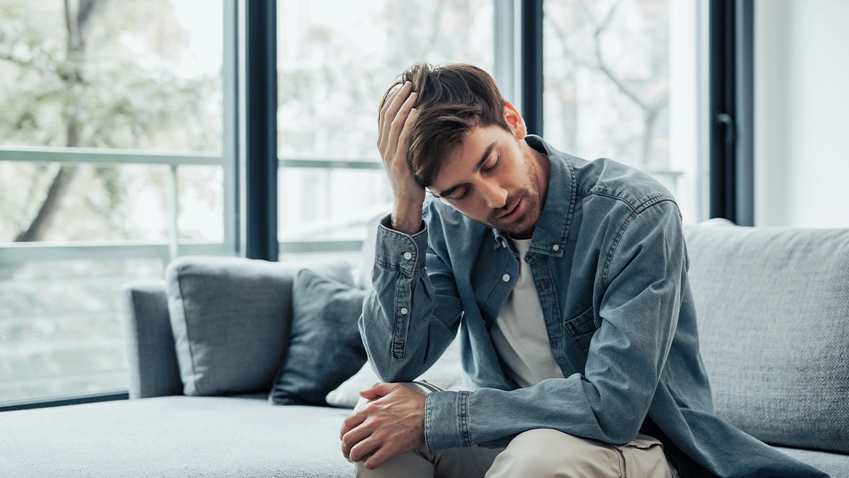 distressed man scratching his head