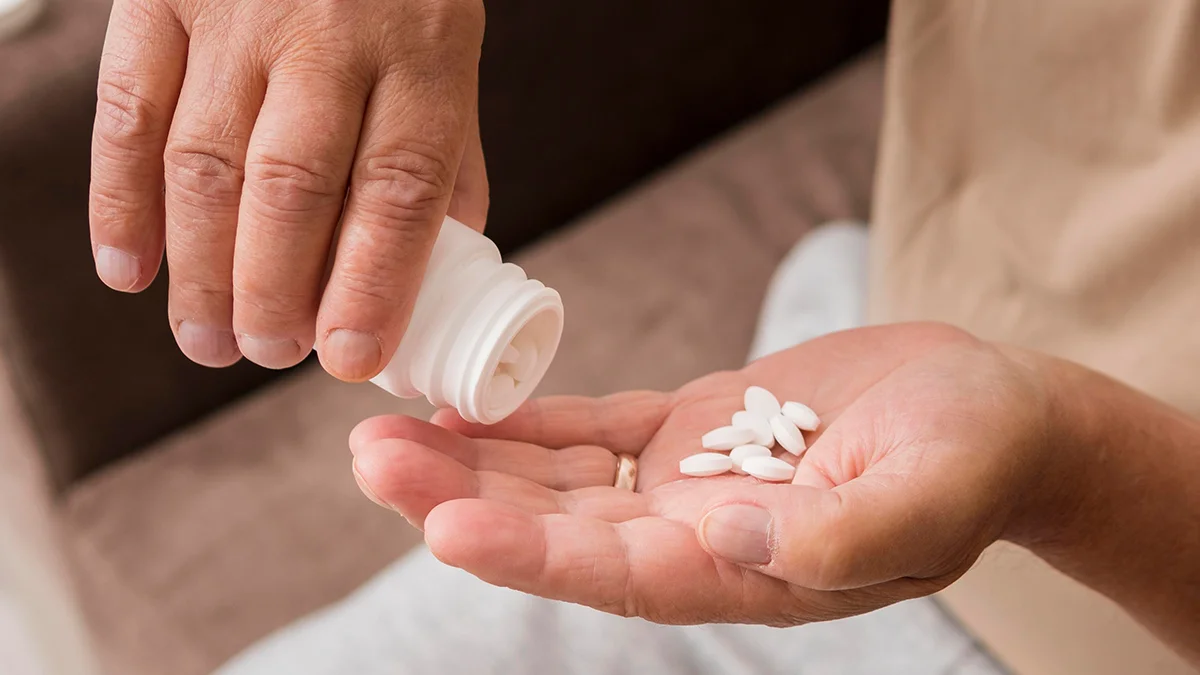 pills being poured into a hand